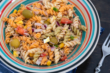 Pasta salad with tuna, egg, tomato, corn and olives