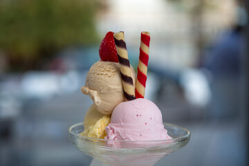 Ice cream cup with three flavors waffles and natural strawberry