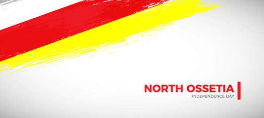 Obraz premium Happy independence day of North Ossetia with brush painted grunge flag background