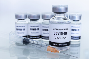 Many Vaccine bottles and syringes for preventing coronavirus or covid-19. Select focus