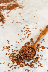 Raw Flax seeds in a wooden spoon