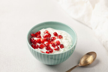 Cottage cheese with pomegranate grains in a bowl on the table. Healthy breakfast