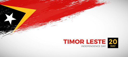 Happy independence day of Timor Leste with brush painted grunge flag background