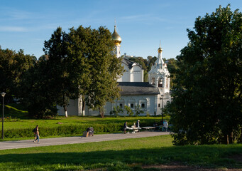 Two white churches (Vvedenskaya and Pyatnitskaya 1547) they stand nearby. On the path, vendors from stalls sell souvenirs. Sergiev Posad, Russia.