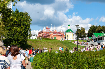 Pilgrims and tourists in a dense stream go to worship the shrines in the monastery of St. Sergius Lavra to St. Sergius of Radonezh. Sergiev Posad, Russia.