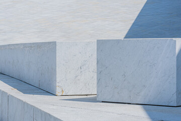 Large marble blocks or slabs on angle against a sloped marble wall in blue and white tones and patterns