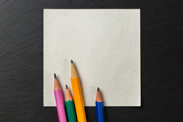 Colored pencils on paper for notes on a gray background. Copy Space