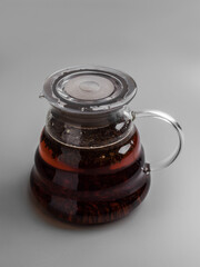 Earl gray hot black tea in glass teapot