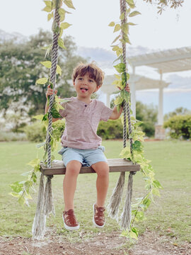 Boy Playing On A Swing In A Park In Orlando Florida At A Golf Course In Lake Nona 