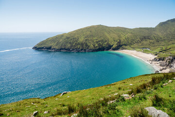 Keem beach, Achill island in county Mayo, Ireland, warm sunny day. Clear blue sky and water of the...