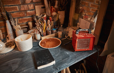 Inside interior of creative studio with elements of pottery and tools for decoration