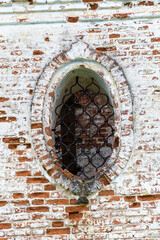 oval window in a brick wall