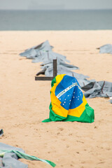 Brazilian flag on top of a cross, during a demonstration against the Brazilian government's policy on coravirus at Copacabana beach in Rio de Janeiro.