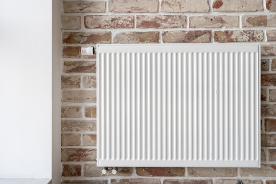 Wall mounted convector heater on brick background