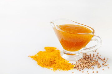 Homemade Curry Sauce in a small bowl. Turmeric powder, coriander or mustard seeds