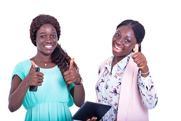 two beautiful happy young women showing thumbs together while holding mobile phones.