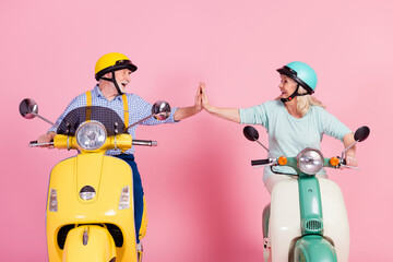 Photo of sweet funny grandmother grandfather riding motorcycle helmets high five arms together...