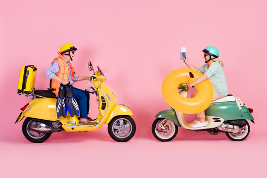 Profile photo of funky senior husband wife driving motorbike dressed helmets ready for vacation isolated pink color background - Powered by Adobe
