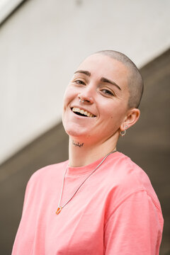 Androgynous person near masonry building on the street