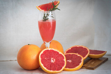Ripe grapefruit  juice and slice grapefruit put on wooden tray hand made cloth background.