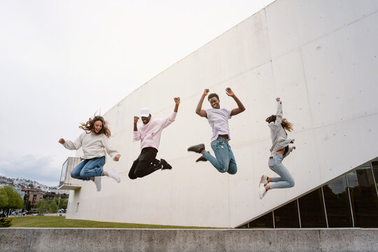 Happy diverse friends having fun together in park