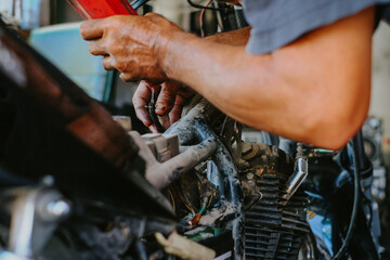Fototapeta na wymiar Oil technician at the carburetor repair or check.