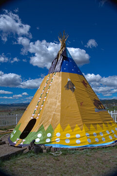 Side view of a 24' tall plains indian teepee in an outdoor setting in western Montana.