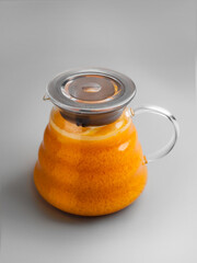delicious vitamin orange sea buckthorn tea in a glass teapot
