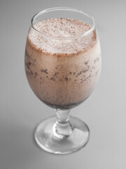 Delicious cold chocolate milkshake in a beautiful glass