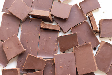background of chocolate pieces on a white background