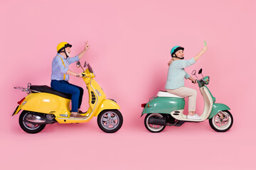 Fototapeta na wymiar Full size profile side photo of happy mature stylish male female ride moped phone selfie show v-sign isolated on pink color background