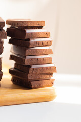 chocolate with nuts on a wooden board, vertical photo