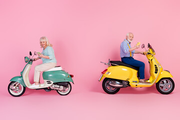 Fototapeta na wymiar Full size profile side photo of two people models ride drive moped wear casual style addict to phone isolated on pink color background