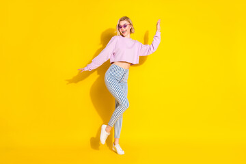 Fototapeta na wymiar Full body photo of young cheerful girl happy positive smile look empty space isolated over yellow color background