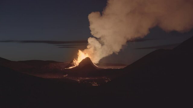 Volcano erupting in valley calm dawn Iceland 2021