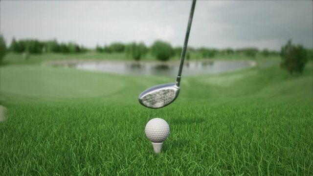 hitting a golf ball with a club on the field front view in slow motion