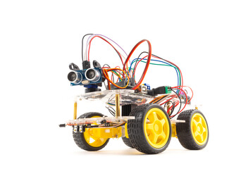 Programmable four wheels drive (4WD) robotic car with obstacle avoidance and line follow ability, isolated on white background with clipping path