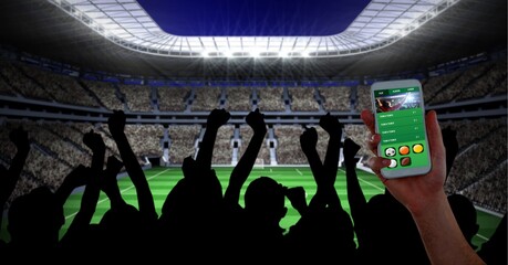 Composition of man using smartphone with sports app over fans at sports stadium