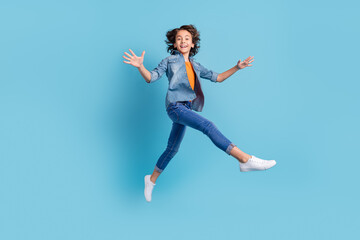 Fototapeta na wymiar Full size profile side photo of young preteen boy happy positive smile go walk jump isolated over blue color background