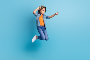 Obraz premium Full length profile side photo of young boy kid jump unhappy angry point finger empty space isolated over blue color background