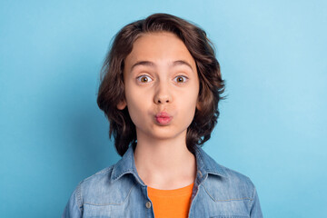 Photo of young preteen boy pouted lips send air kiss you valentine day romantic isolated over blue color background