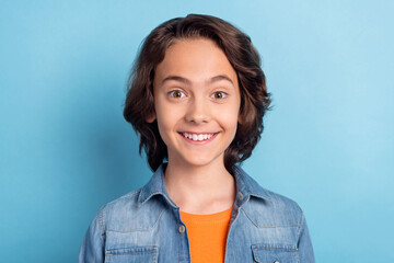 Photo of young cheerful boy happy positive smile brown hair funny isolated over blue color background