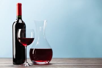 Wine bottle with red wine, wineglass and decanter