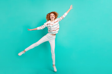 Fototapeta na wymiar Full length body size view of pretty funny girlish cheery wavy-haired girl jumping fooling isolated over bright teal turquoise color background