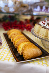 sweet shortbread cookies on a black plate on the table with sweets
