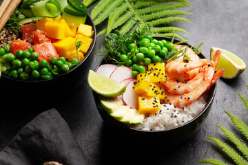 Poke bowls with shrimps, salmon, avocado and mango