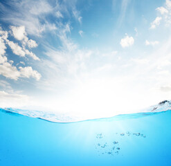 Waterline with sea underwater and blue sunny sky