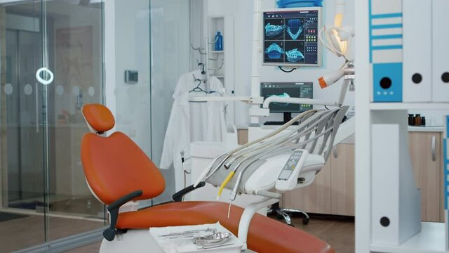 Revealing shot of empty medical stomatology orthodontic hospital office with nobody in it. Professional dental teeth dril and other healthcare instruments prepared for tooth diagnosis