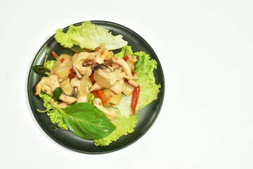 spicy fried squid with basil leaf and chili on plate