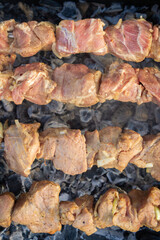 Shish Kebab made from pieces of pork is cooked on skewers on the grill